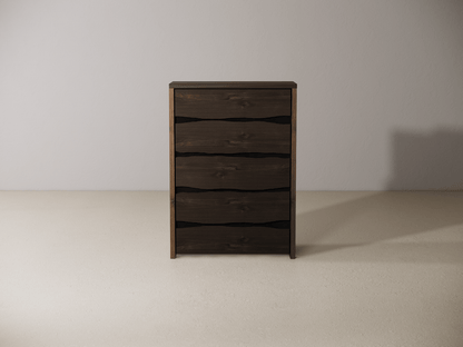 Wooden dresser with five drawers against a plain wall. 