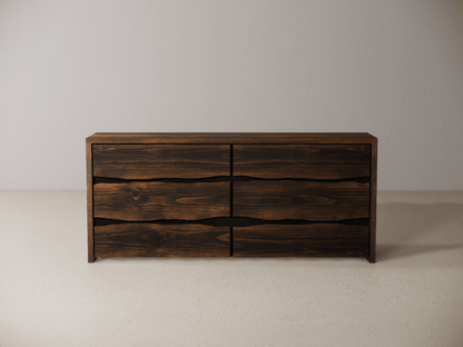 Wooden dresser with six drawers on a neutral background 