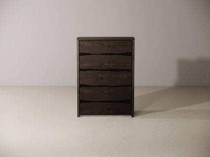 Wooden dresser with five drawers against a plain wall. 